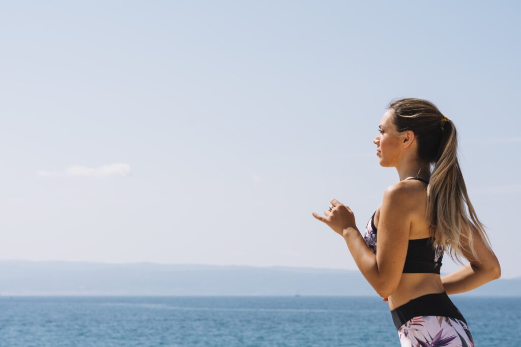 A women jogging by the sea, making a good example of good women's health in Cyprus.